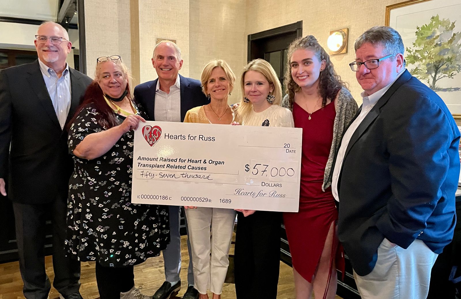 Hearts For Russ Board with the check from 2023, we raised $57,000!